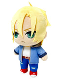 A chibi-style plush toy with short spiky blond hair, green eyes, and a blue jacket over a white shirt, blue pants, and red shoes, shown on a plain white background.