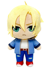 A chibi-style plush toy with short blond hair, green eyes, and an angry expression, wearing a blue jacket, white shirt, blue pants, and red shoes on a plain white background.