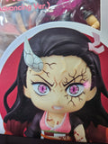 Character figurine with dark hair and pink eyes on a red background