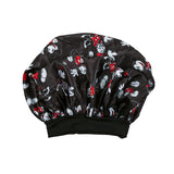 Black shower cap with cartoon character pattern on a white background