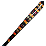 A black fabric lanyard with a repeating Halloween pattern of orange jack-o'-lanterns, red pumpkins, and autumn leaves, shown diagonally on a plain white background.