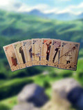 Set of playing cards with character illustrations on a blurred natural background