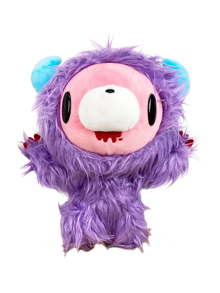 A plush toy character with purple fur, bright blue ears, black oval eyes, and a pink face. It has a white snout and red claws, giving a playful yet eerie vibe.