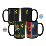 Four black ceramic mugs displaying the Harry Potter Slytherin theme in both hot and cold states. The front-left mug is labeled 'HOT' and shows a green Slytherin body with a badger and gold 'Slytherus' text.