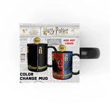 A Harry Potter color-changing mug shown in its retail packaging against a white background. The packaging displays both states of the mug: a black cold state with gold lettering, and a red/blue hot state with a lion and storm graphic.