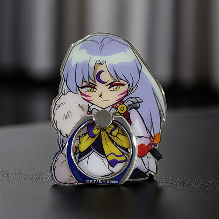 Anime Character-themed phone ring holder on a dark surface with a blurred background