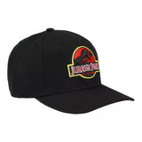 A black structured baseball cap featuring the Jurassic Park logo patch embroidered on the front, set against a plain white background.