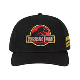 A black structured baseball cap featuring the embroidered Jurassic Park logo on the front and yellow text on the side, shown against a plain white background.