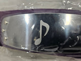 Close up of Naruto Sound Village headband with metal plate engraved with Otogakure Sound Village symbol and packaged in plastic on a gray background