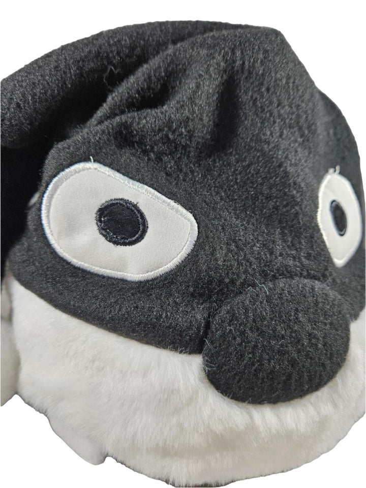 Black and white plush Naruto sleeping hat resembling a penguin on a white background