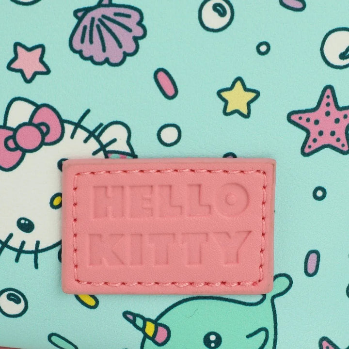 Pink 'HELLO KITTY' patch on a colorful background with cartoon characters.