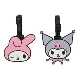 Two cartoon character luggage tags, one pink and one gray with black accents, on a white background.