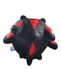 A black plush toy with red accents, photographed against a plain white background. A small blue tag is visible on the left side.