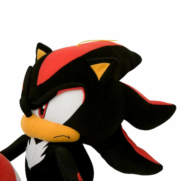 A plush toy of Shadow the Hedgehog, featuring his signature black and red fur pattern, yellow beak, and white chest details, set against a plain white background.