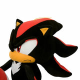 A plush toy of Shadow the Hedgehog, featuring his signature black and red fur pattern, yellow beak, and white chest details, set against a plain white background.