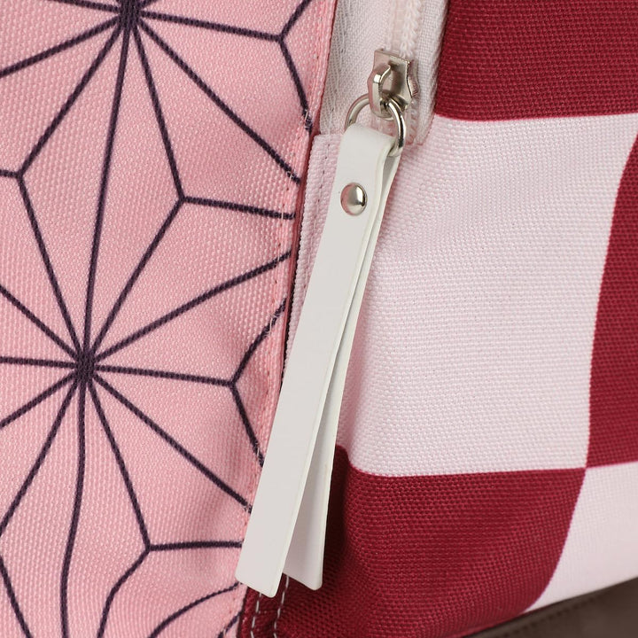 Close-up of a zipper on a pink and red patterned fabric