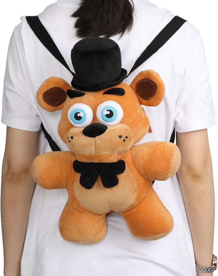 Person wearing a plush toy backpack shaped like a teddy bear with a top hat and bow tie.