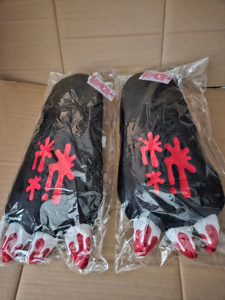Two individually packaged Gloomy Bear black plush paw arm gloves showing red splatter graphics and white claws with red tips, Great Eastern Entertainment.