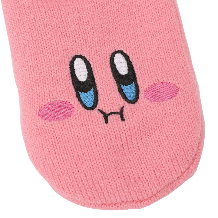 Pink sock featuring a cute, smiling character face with big, expressive blue eyes and rosy cheeks. The knitted texture adds a cozy feel.