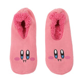 Pink slippers with cartoon faces, featuring big eyes and rosy cheeks. The cozy interior is lined with plush, creating a playful and warm vibe.