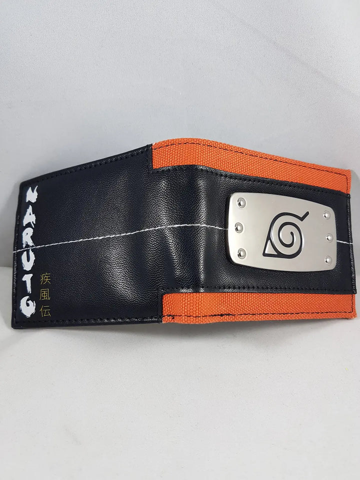 Naruto Leaf Village bi-fold wallet open front angle showing orange canvas band black faux leather exterior Naruto Shippuden logo kanji and etched metal Konoha badge by Bioworld