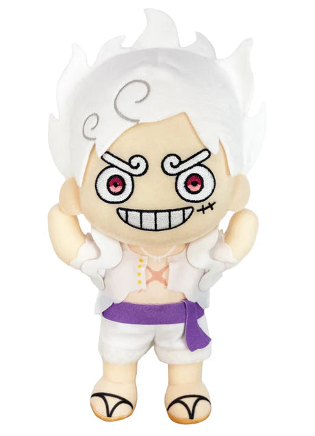 One Piece Luffy Gear 5 Awakening 9 inch Plush Doll front view showing white voluminous Sun God Nika hair embroidered spiral eyebrows crimson eyes grinning smile white open-chest top with gold Nika mark purple sash belt white shorts and tan sandals officially licensed by Great Eastern Entertainment
