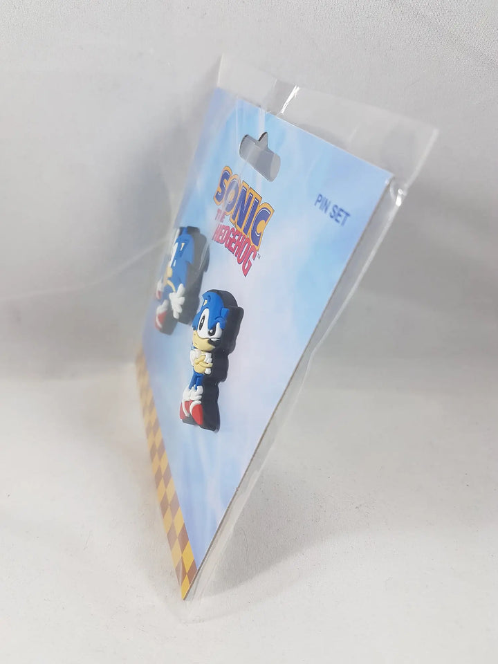Side angle view of Sonic the Hedgehog Classic Sonic Sneak and Pose lapel pin set of 2 in official sealed packaging showing pin card thickness and hang tab by Great Eastern Entertainment licensed by SEGA